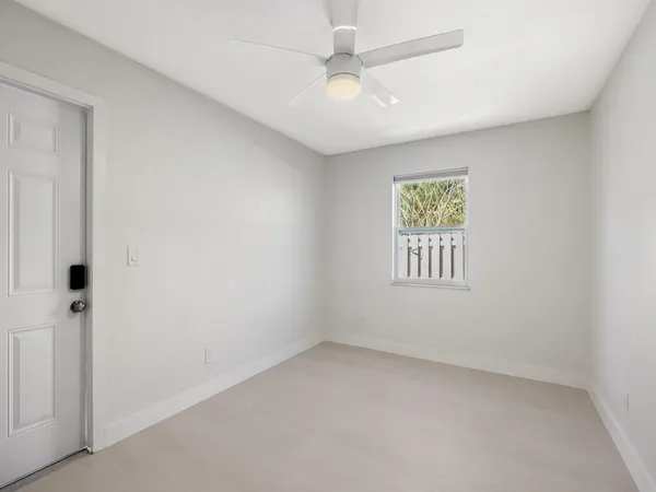 a view of a house with backyard and deck