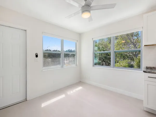 a view of wooden floor and windows in a room