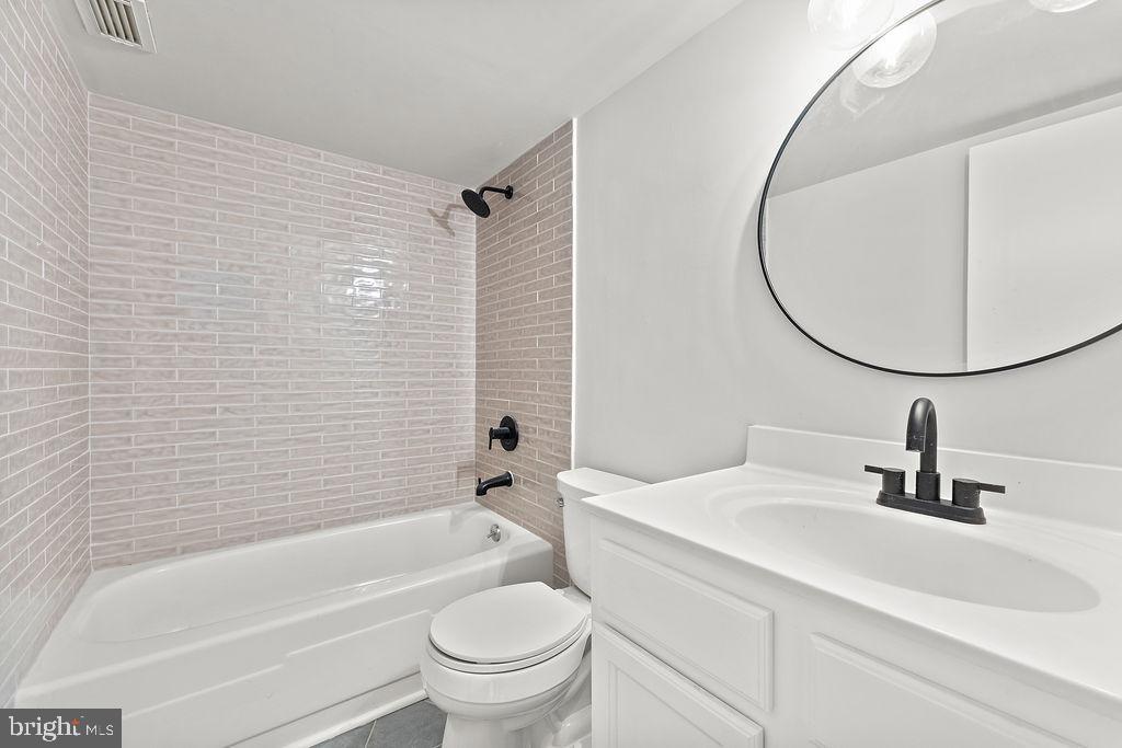 4500 South Four Mile Run Drive, Unit 1113 Arlington, VA 22204 - Photo 23 of 36 a bathroom with a sink a toilet and a mirror