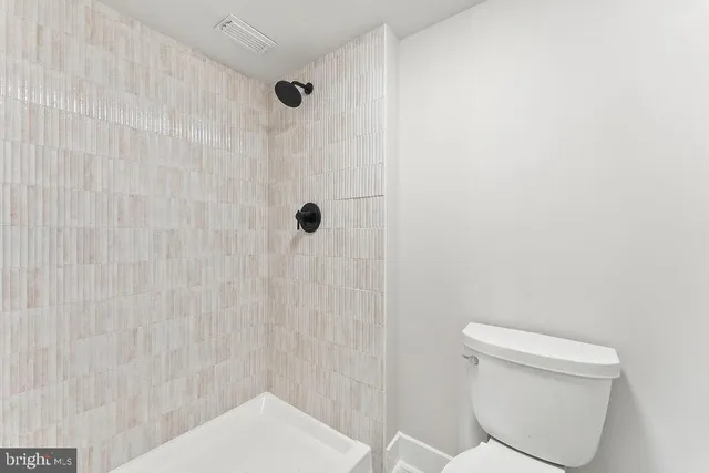 a bathroom with a shower and a toilet