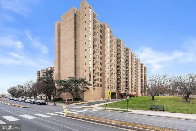 a view of a tall building next to a road