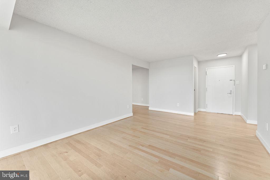 4500 South Four Mile Run Drive, Unit 1113 Arlington, VA 22204 - Photo 5 of 36 a view of an empty room with wooden floor