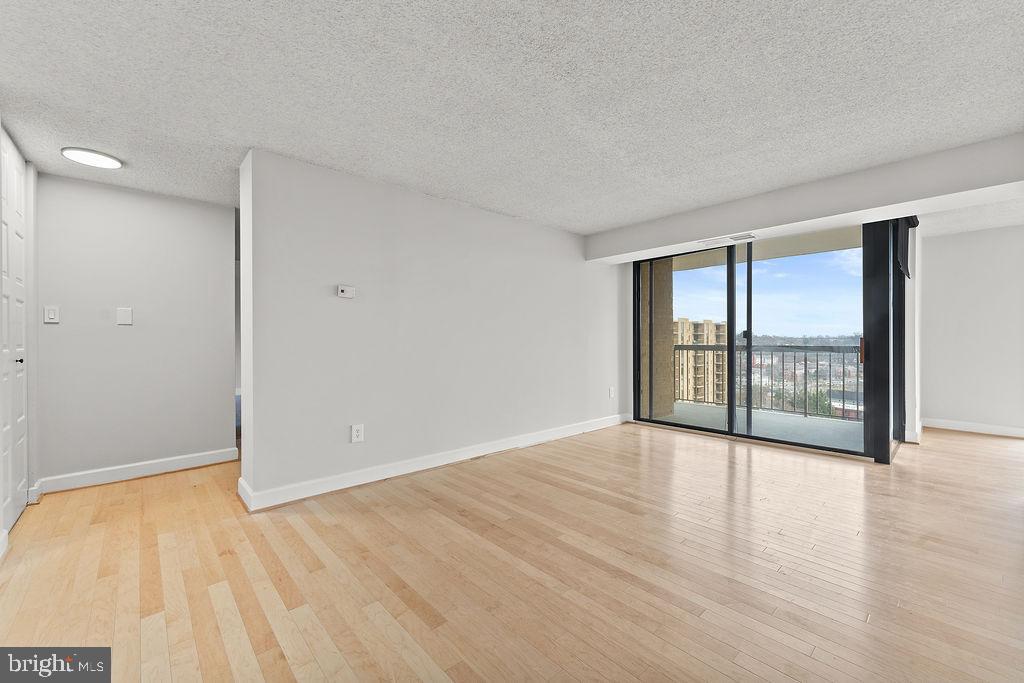 4500 South Four Mile Run Drive, Unit 1113 Arlington, VA 22204 - Photo 7 of 36 wooden floor in an empty room with a window