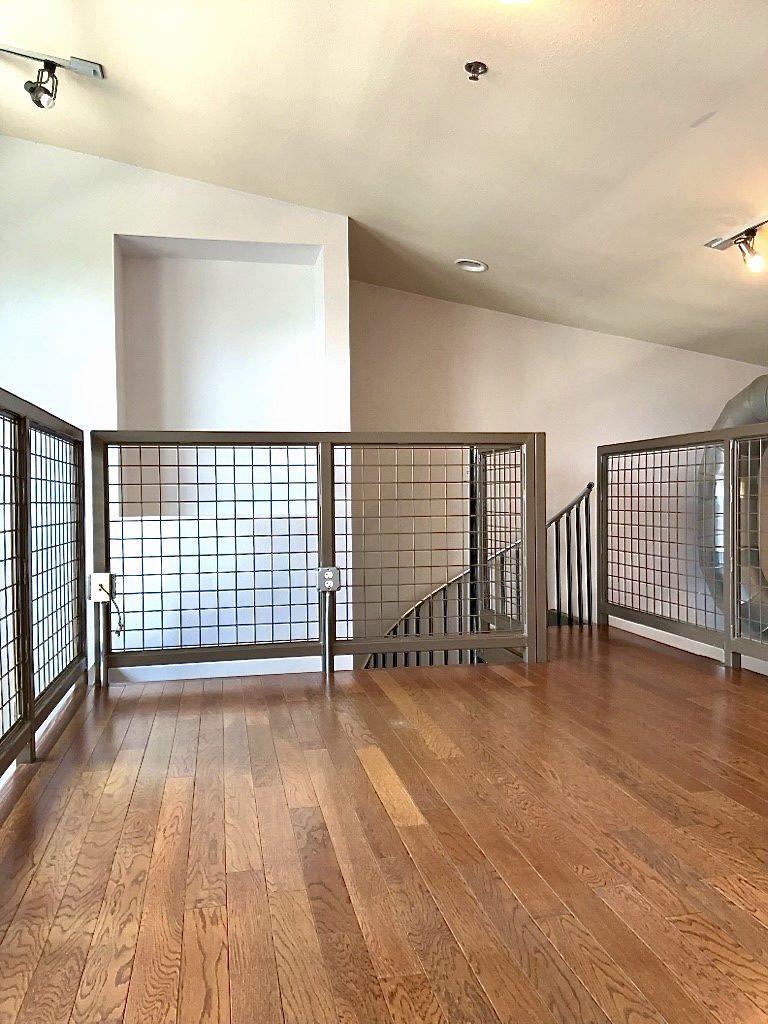 1601 East Cesar Chavez Street, Unit 306 Austin, TX 78702 - Photo 12 of 19 a view of an empty room with wooden floor