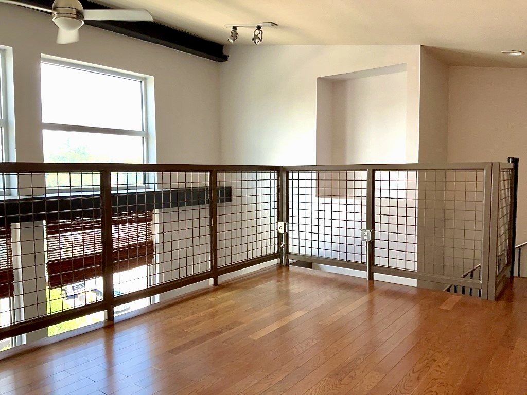 1601 East Cesar Chavez Street, Unit 306 Austin, TX 78702 - Photo 13 of 19 a view of an empty room with wooden floor and a window