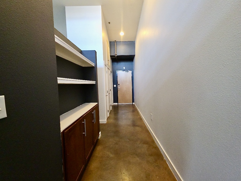 1601 East Cesar Chavez Street, Unit 306 Austin, TX 78702 - Photo 2 of 19 a hallway with closet and wooden floor