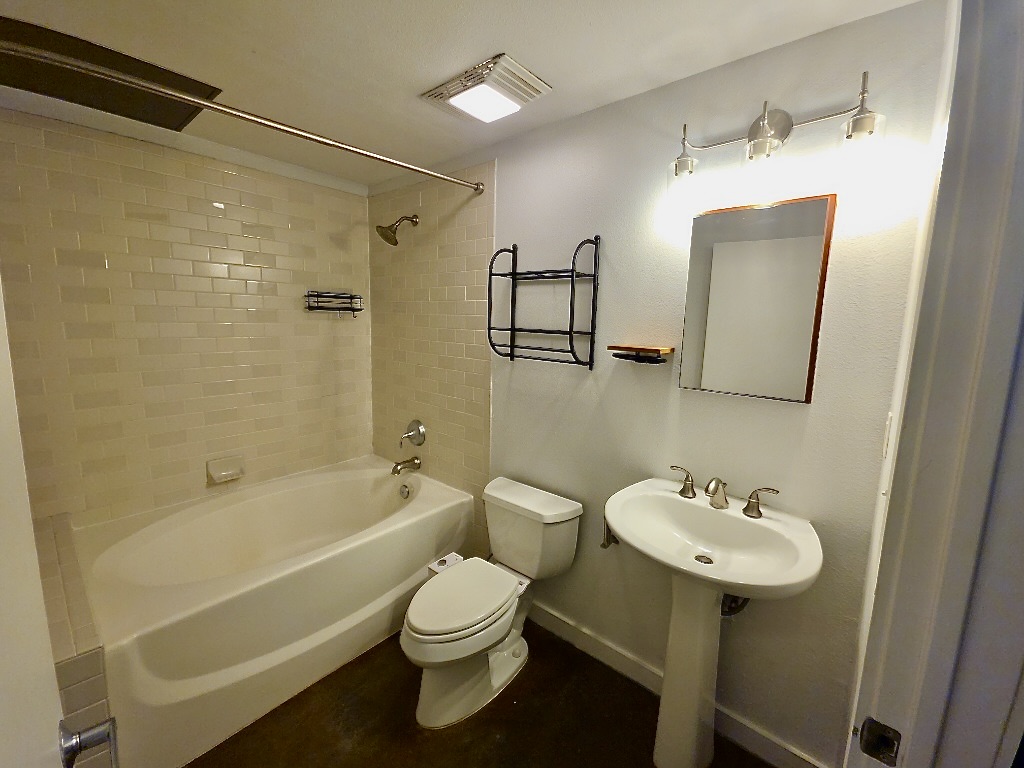 1601 East Cesar Chavez Street, Unit 306 Austin, TX 78702 - Photo 10 of 19 a bathroom with a sink toilet a shower and bathtub