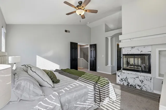 a bedroom with a bed and a television