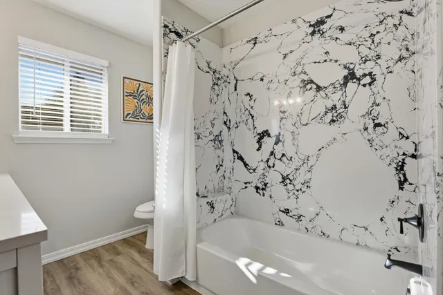 a bathroom with a bathtub and shower