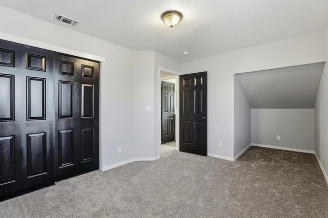 an empty room with closet area