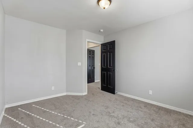 a view of a house with a door and wooden walls