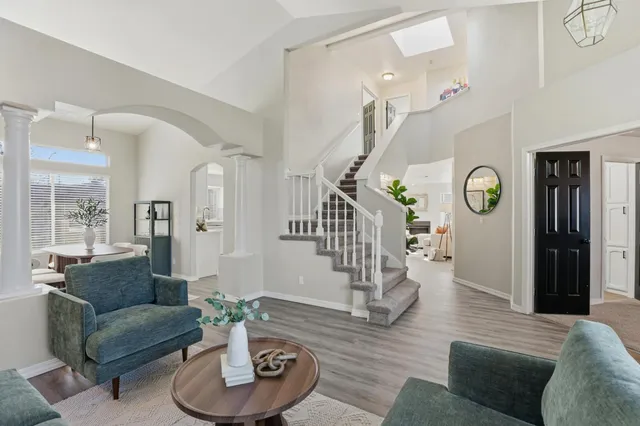 a living room with furniture and wooden floor