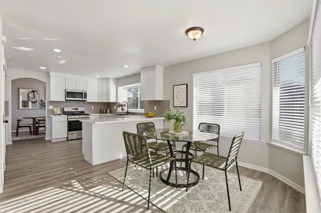 a view of a dining room with furniture and wooden floor