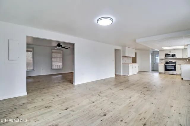 a view of a kitchen with a sink and a refrigerator