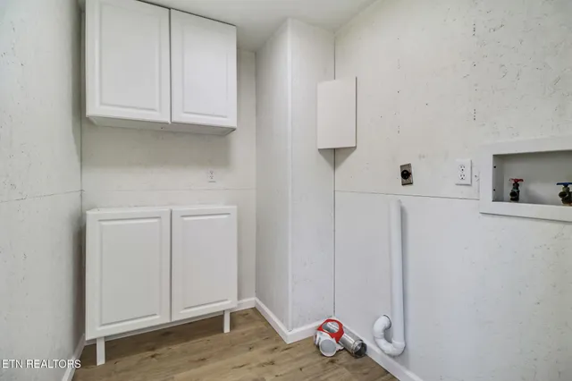 a view of kitchen with white cabinets