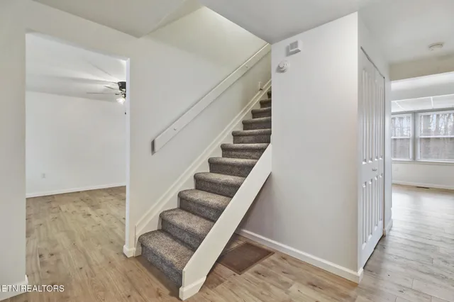 a view of entryway and hall with wooden floor