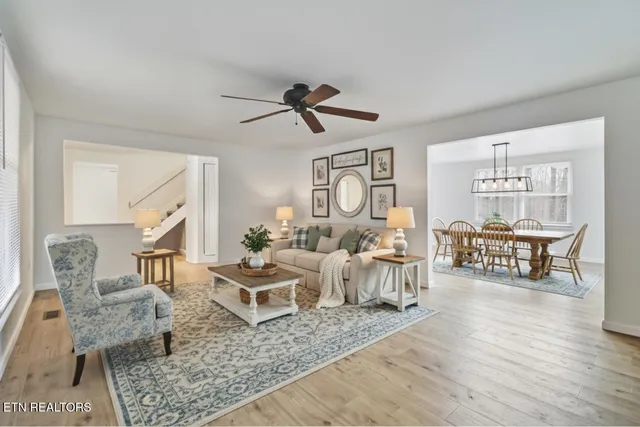 a living room with furniture and wooden floor