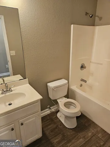 a white toilet sitting next to a bathroom sink