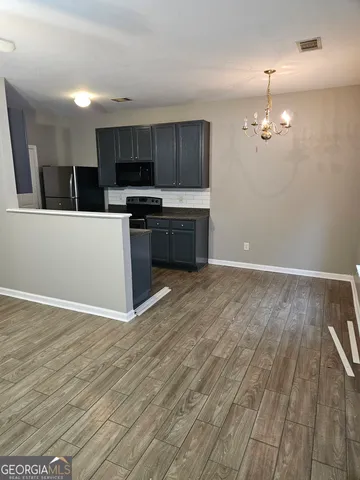 a view of kitchen with sink microwave and stove