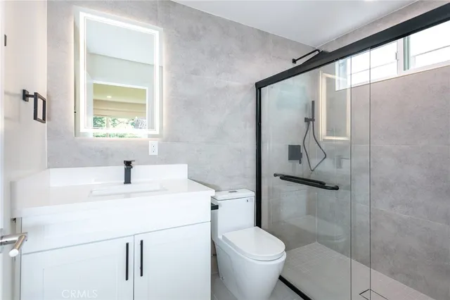 an empty room with windows and a fireplace