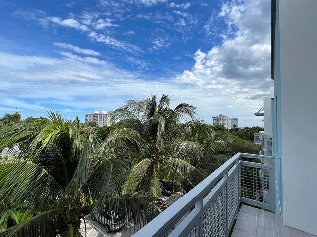 a view of a balcony with wooden floor and fence