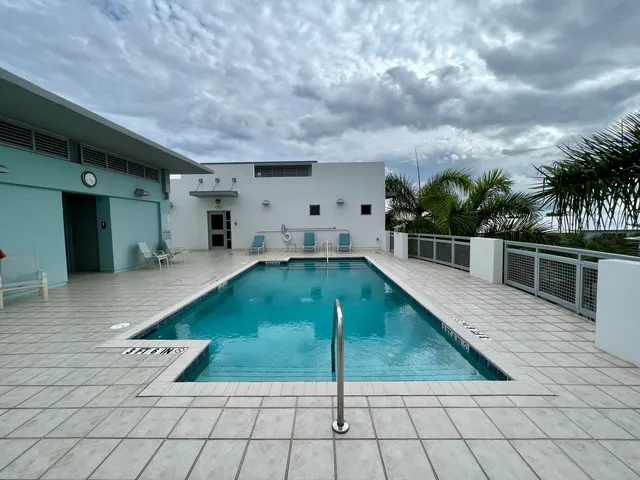 a view of swimming pool with seating space and barbeque in living room