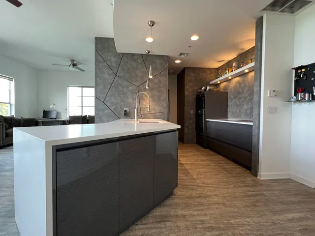 a kitchen with stainless steel appliances granite countertop a sink and a refrigerator