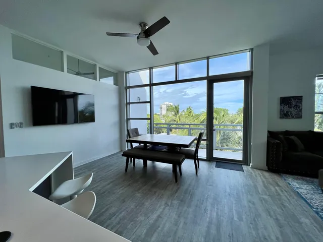 a view of a livingroom with furniture window and wooden floor