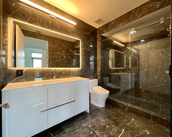 a bathroom with a sink toilet and shower