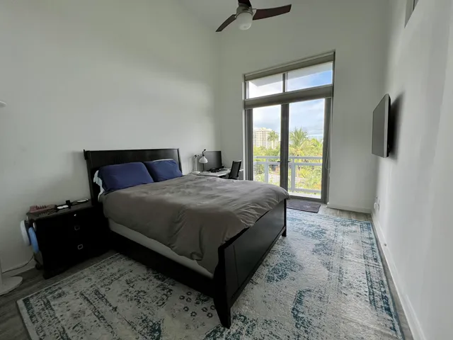 a bedroom with a bed and flat screen tv
