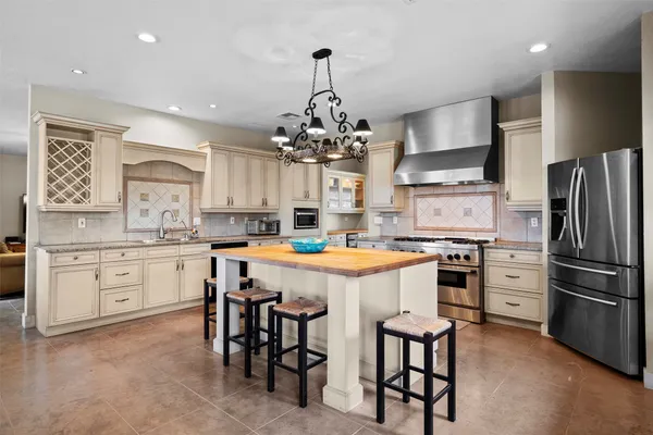 a kitchen with cabinets and stainless steel appliances