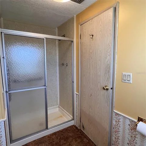 a bathroom with a glass shower door