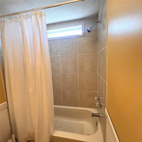 a bathroom with a shower and a tub