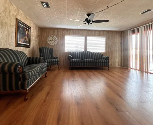 a living room with furniture wooden floor and window