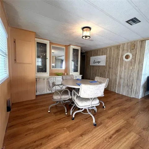 a view of a dining room with furniture and wooden floor