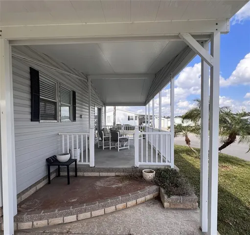 a view of a porch with a chairs and table in a patio