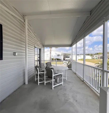 a dining room with furniture and a floor to ceiling window