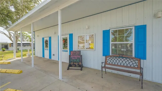 a view of a porch with a bench and floor to ceiling window