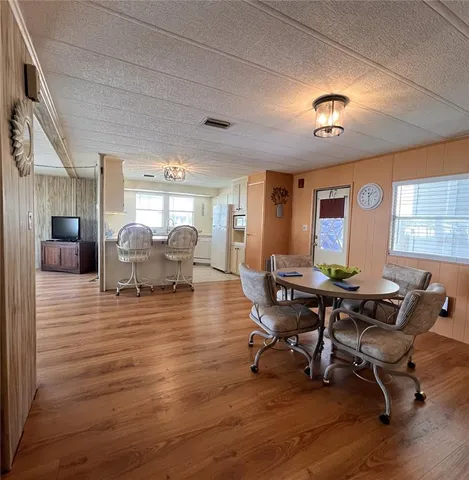a workspace with furniture a rug and wooden floor