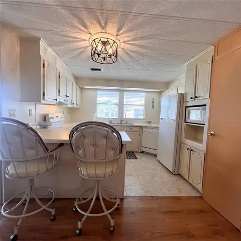 a view of a kitchen with workspace and windows