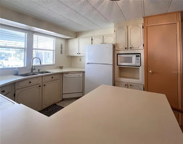 a kitchen with a sink appliances and cabinets