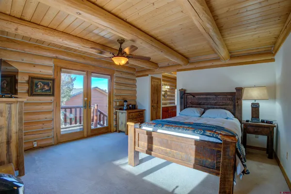 a bedroom with a bed and a tv