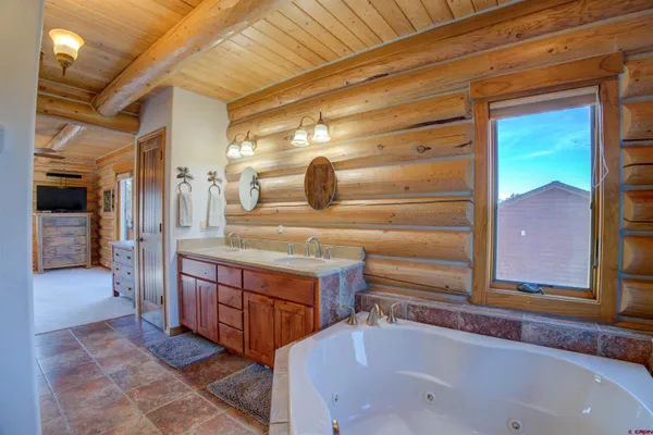 a bathroom with a tub and a sink