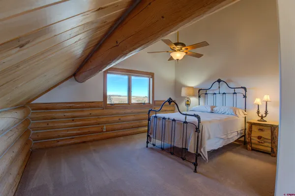 a bedroom with bed and a chandelier