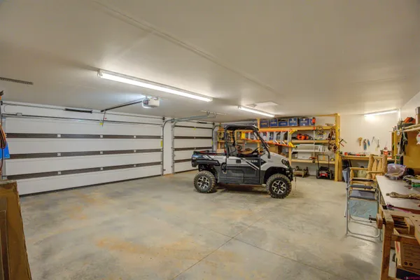 a view of parking garage with cars and other equipment