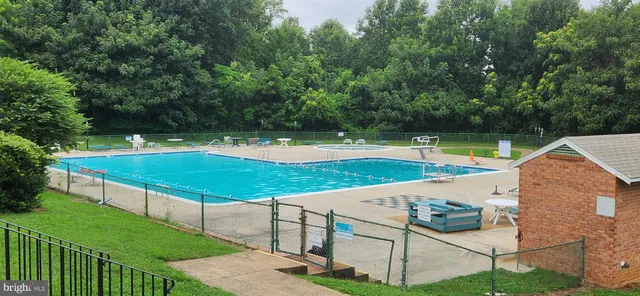 a view of yard with swimming pool and outdoor seating