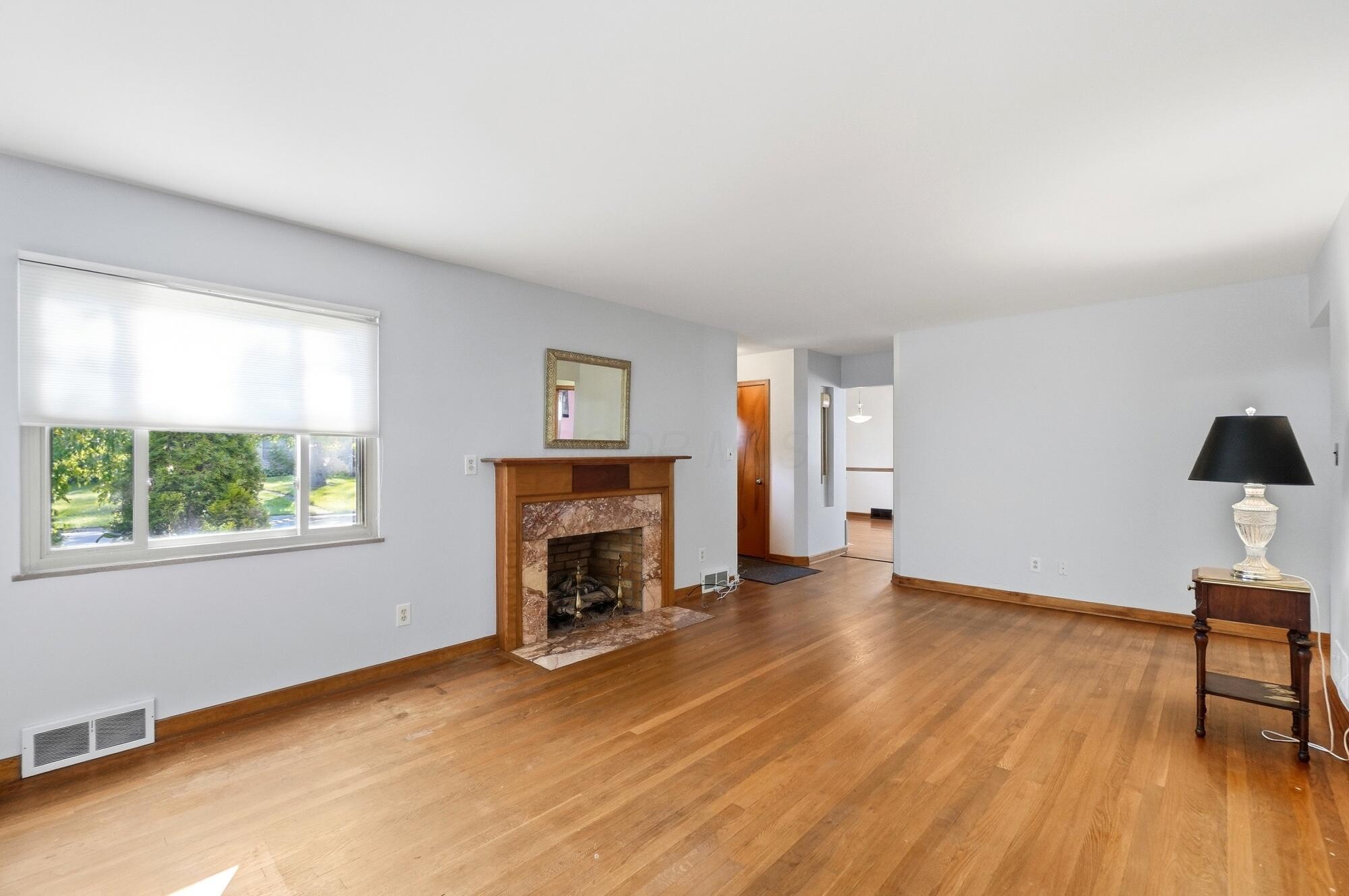 559 Enfield Road Columbus, OH 43209 - Photo 7 of 33 The living room is spacious with large windows that overlook the yard.