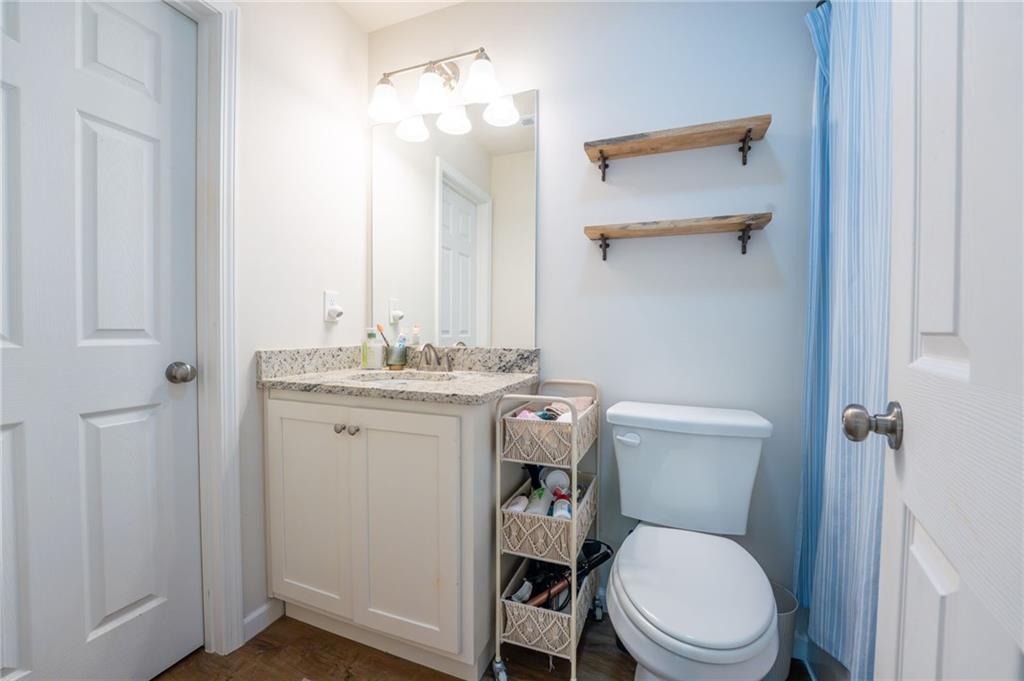 118 Wash Rider Road Dahlonega, GA 30533 - Photo 24 of 37 a bathroom with a toilet sink and mirror