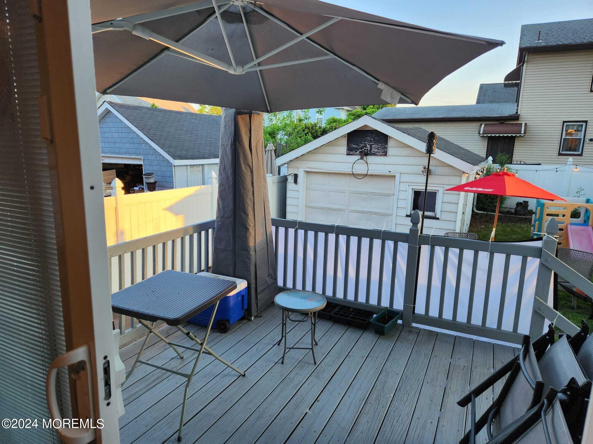 406 Rutherford Avenue Lyndhurst, NJ 07071 - Photo 3 of 5 an outdoor space with furniture and umbrella
