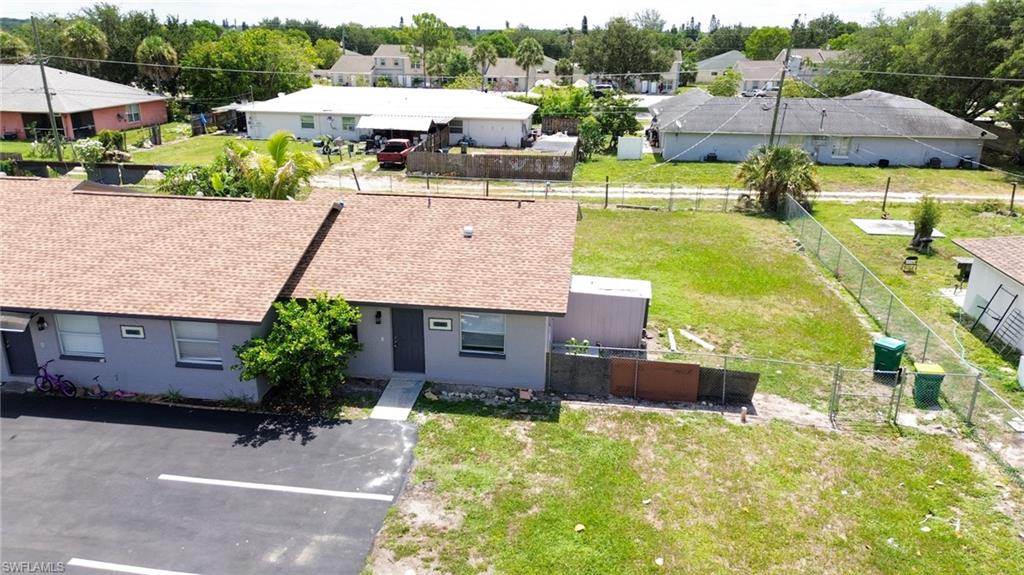 1940 48th Street Southwest Naples, FL 34116 - Photo 3 of 33 Gray exterior featuring a shingle roof and a concrete walkway